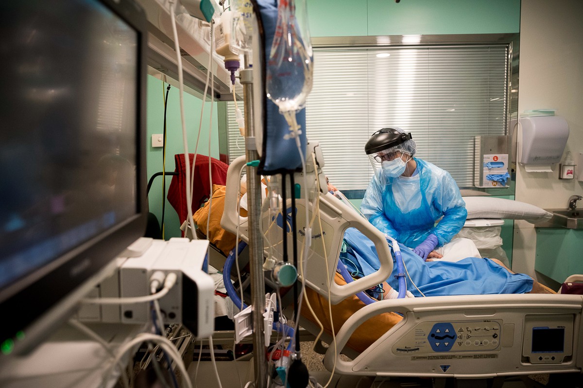 Una infermera atenent un pacient a la UCI de l'Hospital Universitari de Vic. - Consorci Hospitalari de Vic Una infermera atenent un pacient a la UCI de l'Hospital Universitari de Vic. - Consorci Hospitalari de Vic