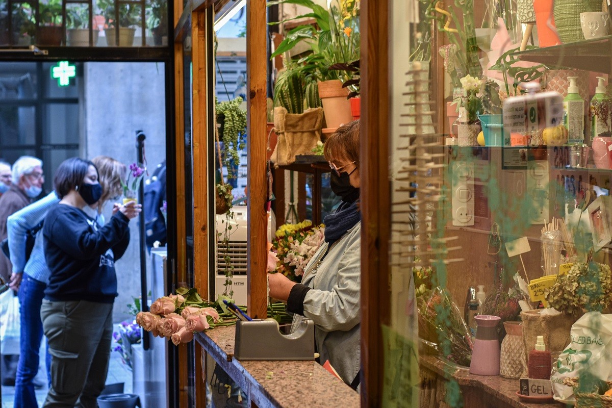 La mestressa de la floristeria Petit Jardí preparant un ram de roses.  - Marina León