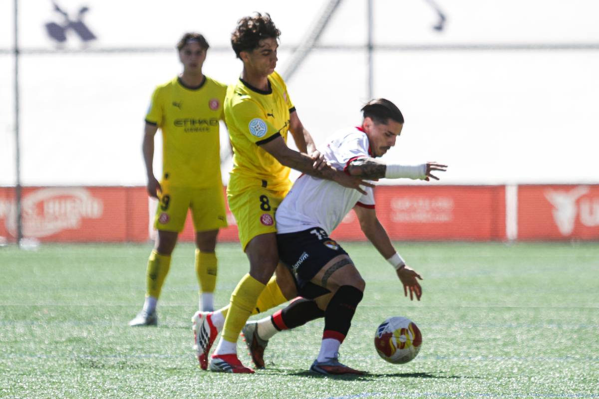 Josemi Castañeda controla la pilota davant d'un jugador del Girona  - Lluís Clotet