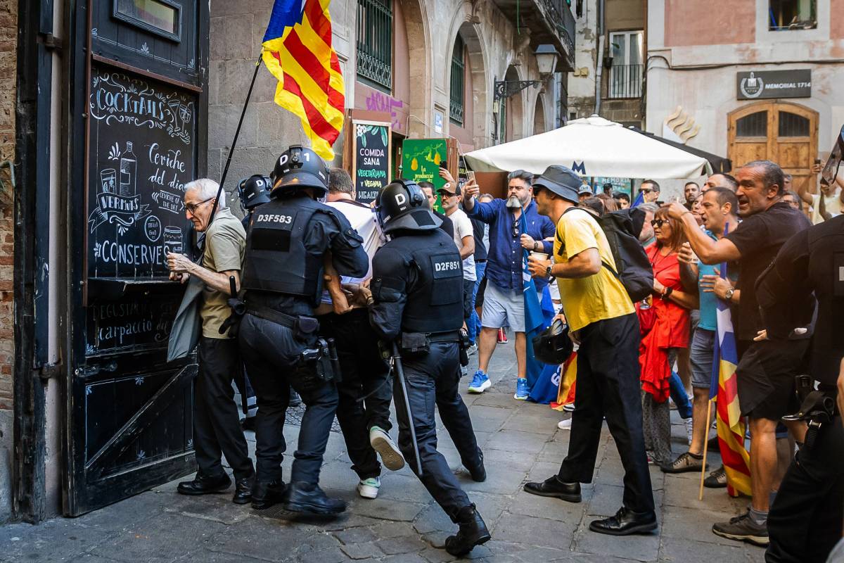 Retinguts pels Mossos d'Esquadra després de llançar pintura durant l'acte d'Aliança Catalana al Fossar de les Moreres - Hugo Fernández